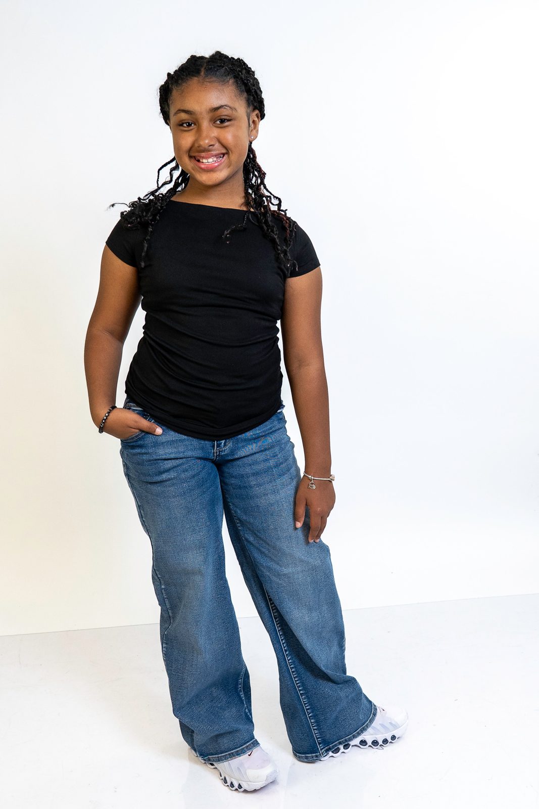 Eleaya Neveah full-length photo, black top and jeans